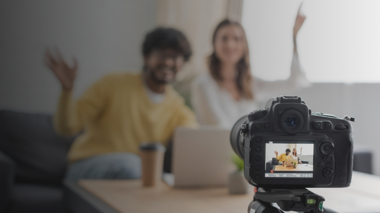 A real estate agent recording a property video tour with professional camera equipment, showcasing modern home interiors
