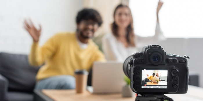 A real estate agent recording a property video tour with professional camera equipment, showcasing modern home interiors 